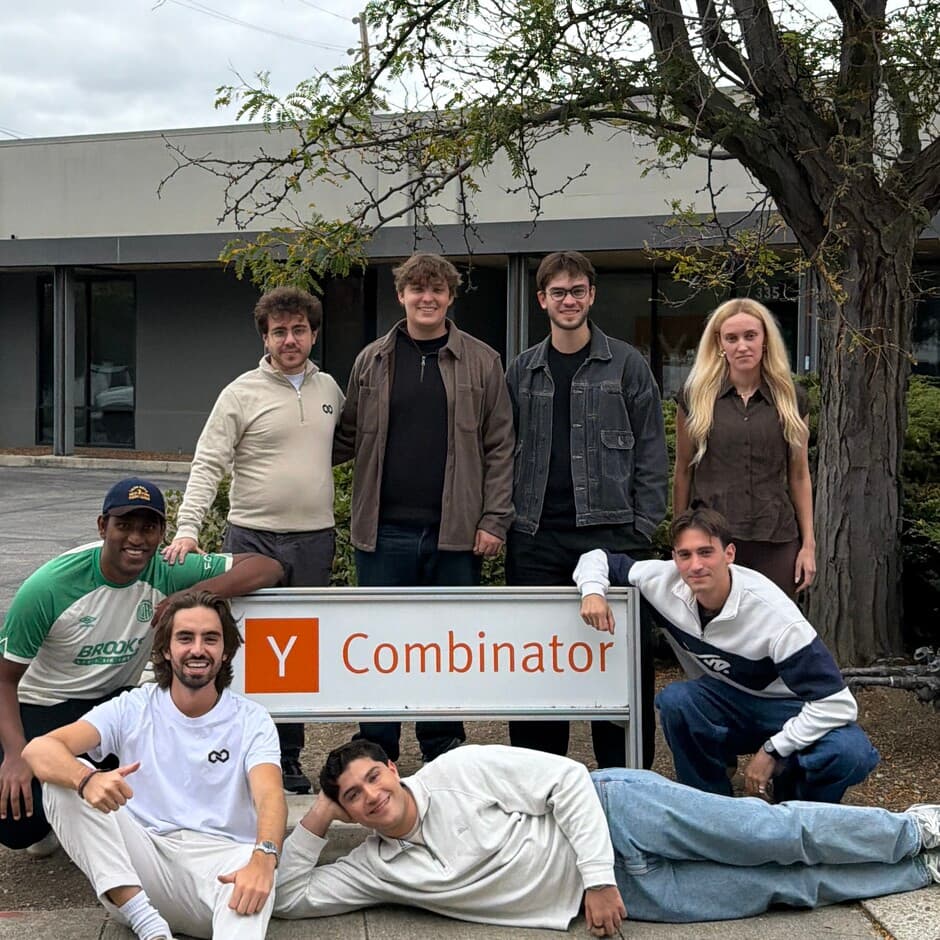Invertix team photograph in front of a Y Combinator sign